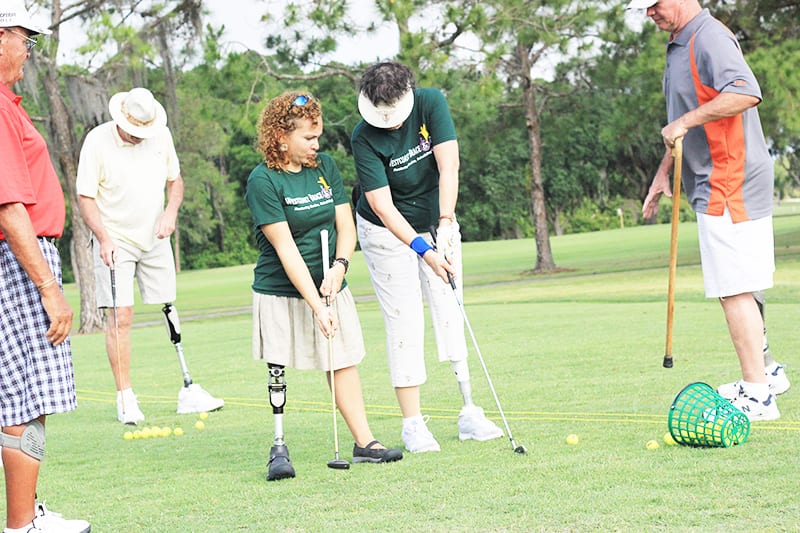 amputee patient with a prosthetic leg playing gold