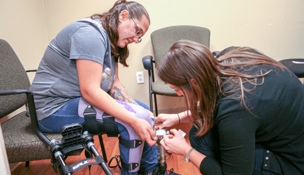 woman being fit by a prosthetist for a prosthosis device