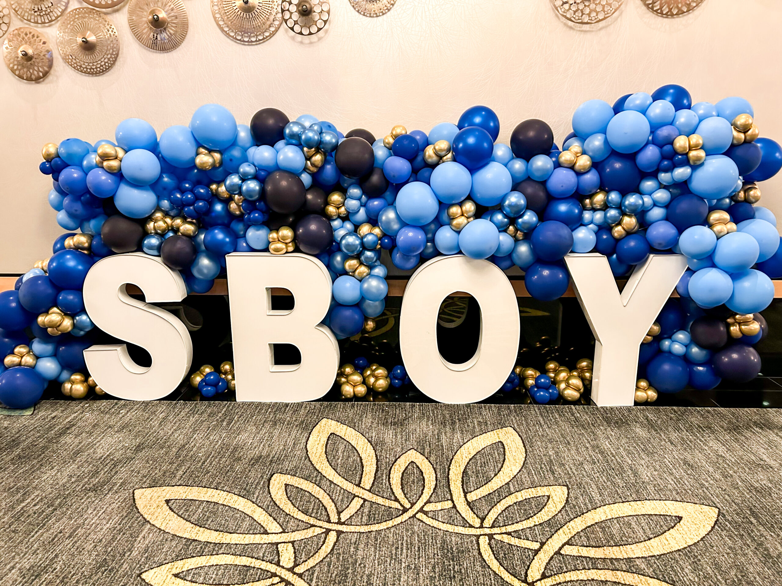 SBOY letters and blue balloons.